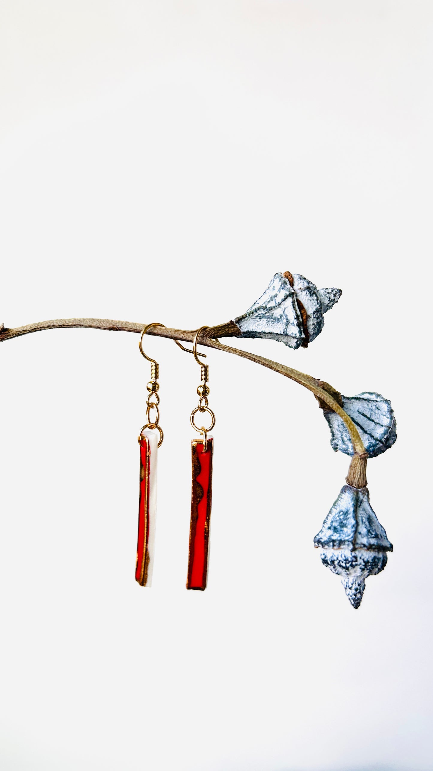 Long red porcelain earrings with 22 k gold luster