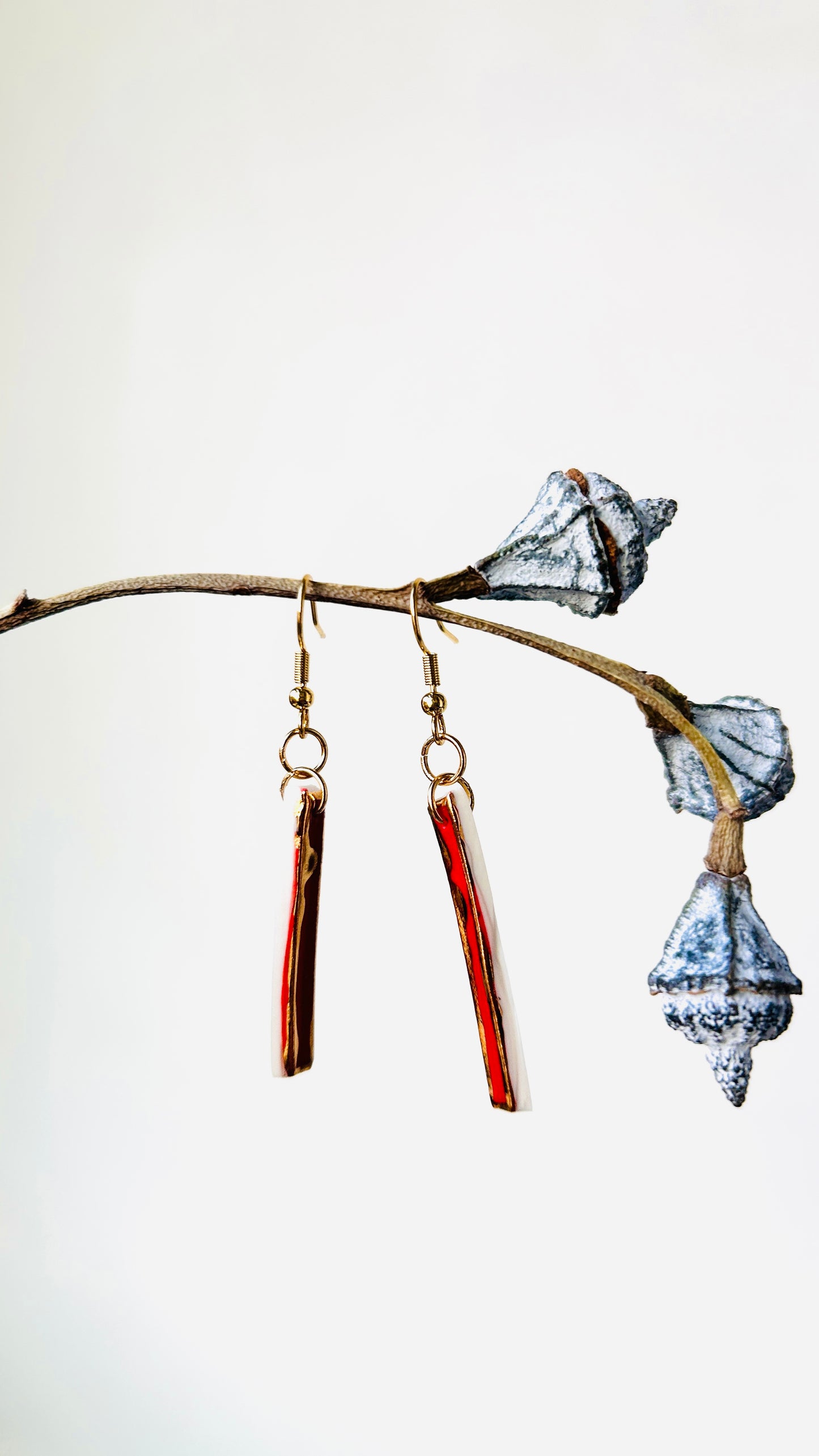 Long red porcelain earrings with 22 k gold luster